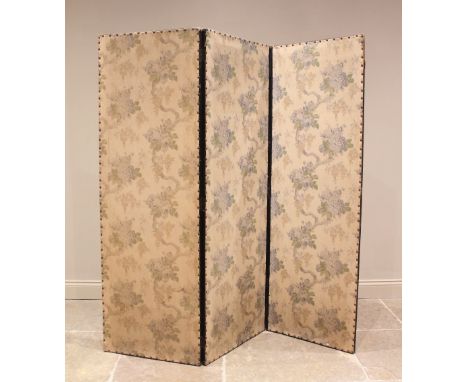 A late Victorian ebonised three fold room screen, the foliate fabric panels with peripheral stud detail upon an ebonised fram