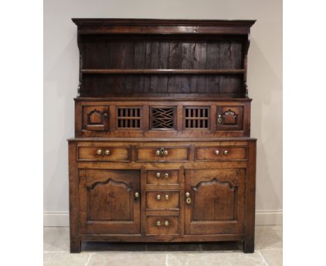 A mid 18th century oak tridarn, of pegged construction, the superstructure canopy with a moulded cornice over a single shelf,