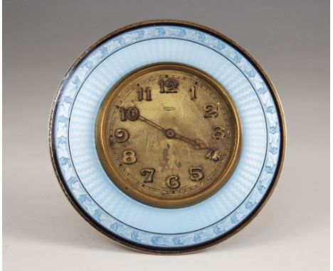 An enamelled 8 day desk clock, the circular dial with Arabic numerals and outer seconds track, the border decorated with blue