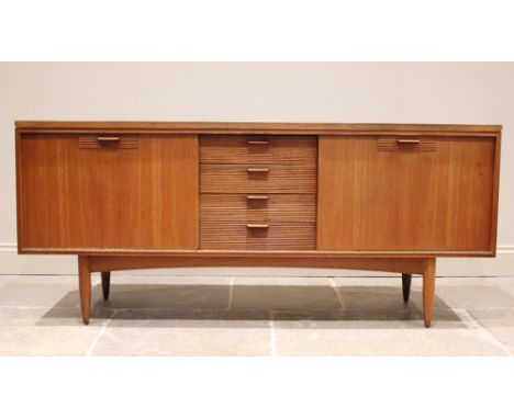 A mid 20th century 'Long John' style teak sideboard, the four central tambour effect drawers flanked by a pair of fall-front 