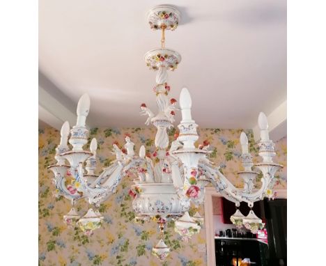 An Italian style ceramic eight branch chandelier, late 20th century, the wrythen baluster stem extending to eight 'S' shaped 