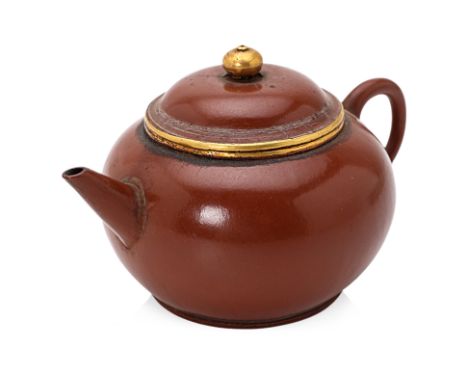 A SMALL POLISHED AND GOLD MOUNTED YIXING TEAPOT
Globular form, loop handle and tapered spout, rim, cover edge and finial with