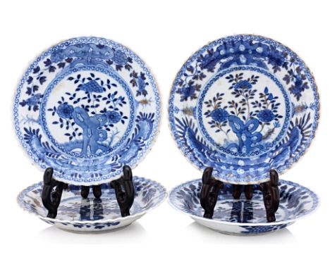 A GROUP OF FOUR BLUE AND WHITE SAUCERS
Each similarly decorated with flowering foliage issuing from a rocky outcrop, stylised