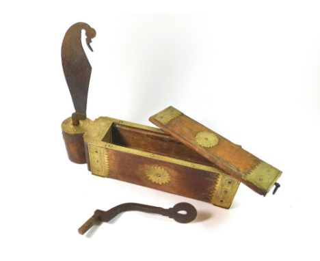 COCONUT GRATER. An Indian brass mounted wooden coconut grater containing tools. Length 40cm.  Please note that all items in t