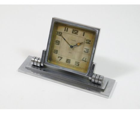 ART DECO CLOCK. An Art Deco chromium cased Crometa, 8-Day desk clock with adjustable dial, luminescent numerals & yellow enam