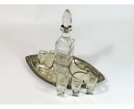 LIQUEUR SET. An Art Deco liqueur set, the decanter with Hukin & Heath silver collar, Birmingham 1921. The silver plated stand
