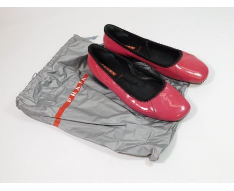PRADA. A pair of Prada Fuchsia patent ballerina shoes with elastic straps. Size 39.5cm. With original branded Prada bag.  Ple