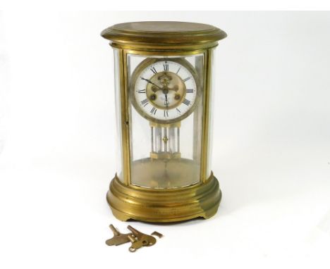 MANTEL CLOCK. An Edwardian, oval, four glass mantel clock, the case with bevelled glass panels. The movement striking on a co