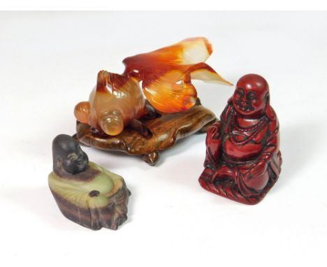 AGATE FISH ETC. A polished agate carving of a fish, length 6.5cm, fitted onto a hardwood stand. Also, two small models of imm