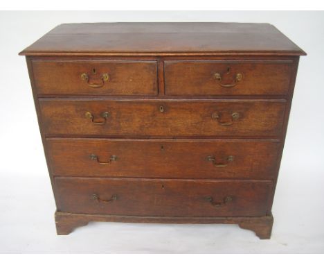 A George III oak chest of drawers, the top with moulded edge above two short and three graduated long drawers, with brass swa