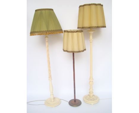 A rosewood and brass bound standard lamp and two others cream painted.