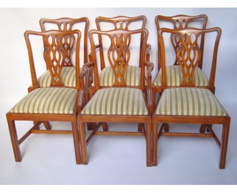 A set of six George III style stained beech dining chairs, including two elbow chairs, with pierced splats and drop in seats,