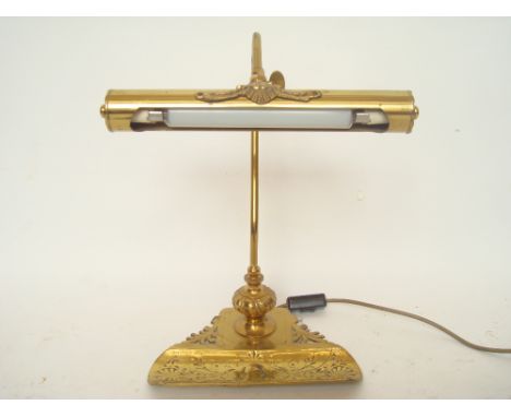 An Edwardian brass desk lamp with pen tray.  
