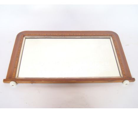 A late Victorian parquetry inlaid walnut overmantle mirror, on ceramic feet.  