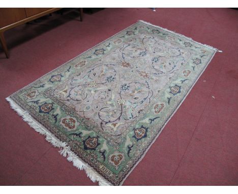 Middle Eastern Wool Tasseled Rug, tightly knotted with allover floral decoration to tan centre panel and olive green border, 