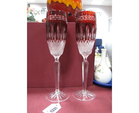 Pair of Waterford Clarendon Ruby Glass Flutes, with tapering hexagonal stems on star cut bases.