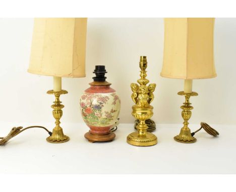 A pair of brass floral table lamps with shades, height to top of shade 51cm, a further brass table lamp, the column of balust