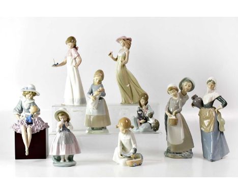 LLADRÓ; a figure of a young lady holding a doll, seated on a block, height 27.5cm, also a Lladrό figure of a young lady seate