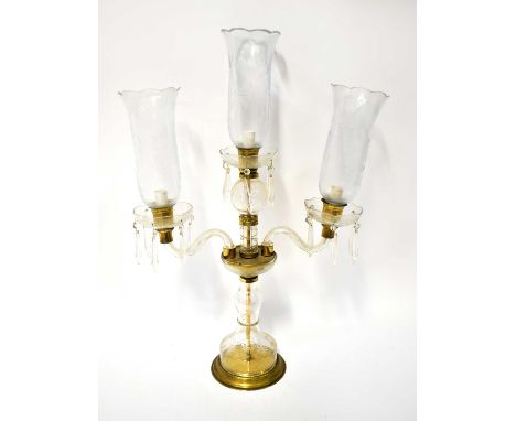 A Victorian-style cut glass and etched three-branch lamp, each branch with a hurricane lamp style shade and crystal drops, he