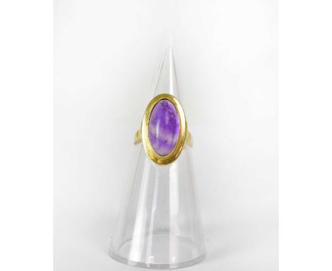 A 14ct yellow gold ring set with an oval amethyst cabochon, size R, approx. 5g.Condition Report: - Stamped '585' to shank int