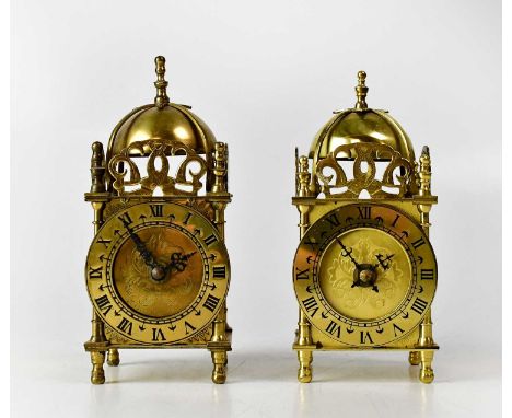 A pair of reproduction brass-cased lantern clocks, the chapter rings set with Roman numerals, surmounted by dials, heights 18