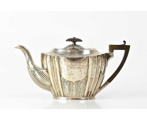 A 19th century hallmarked silver teapot, demi-gadrooned and fluted with wooden knop and handle, marks rubbed, height 14cm, ap