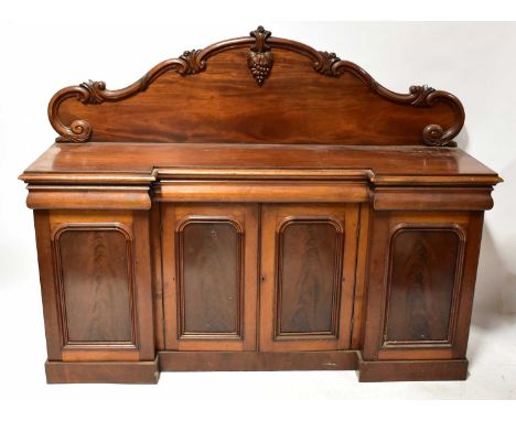A Victorian mahogany chiffonier breakfront sideboard, the arched carved top with bunch of grapes motif, above a base of three