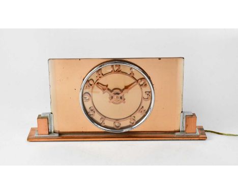 An Art Deco peach glass mantel clock, the dial set with Arabic numeral chapter ring, on chrome and copper-effect stepped supp