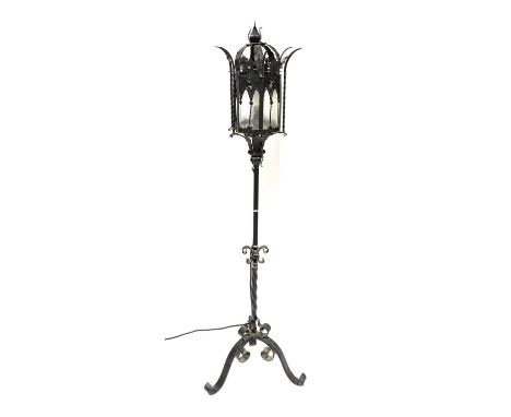 Two Continental wrought iron standard lamps, one with a Gothic-style lantern, height 140cm, the other with a modern storm lan