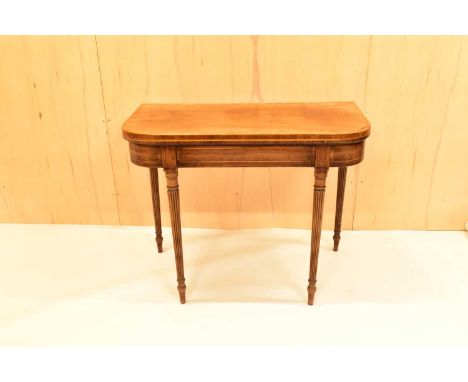 A 19th century mahogany card table, with lift-up top revealing green felt covered table, raised on fluted tapered supports, w