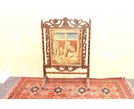 A large Victorian oak tapestry fire screen, the central machine tapestry depicting Continental scene of figures looking out o