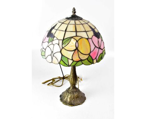 A Tiffany-style table lamp, with leaded stained glass shade depicting butterflies amongst flowers, on moulded brass base, hei