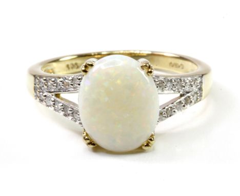 A 9ct yellow gold ring set with a cabochon cut opal and diamond set shoulders, (N).