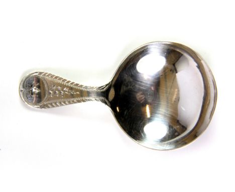 A hallmarked silver caddy spoon.