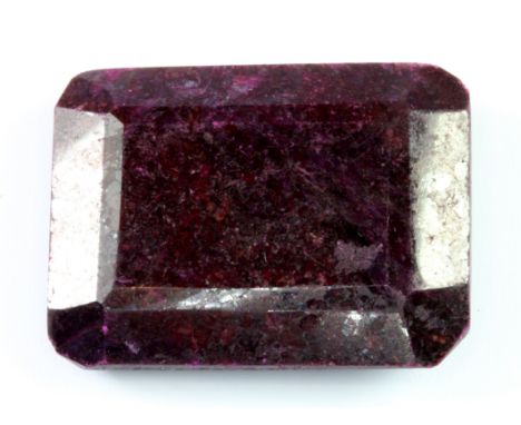 An unmounted 111ct emerald cut ruby, 3.7 x 3cm.