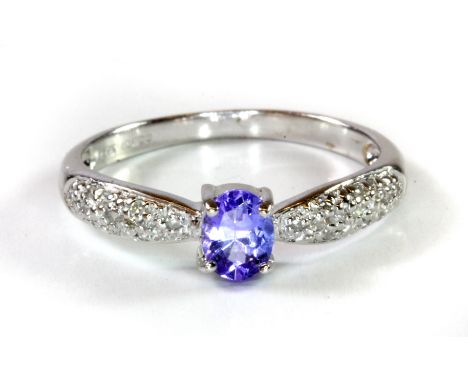 A 9ct white gold tanzanite and diamond set ring, (L.5).