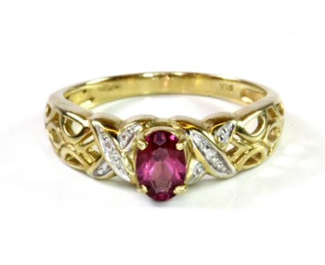 A 9ct yellow gold ring set with a n oval cut tourmaline and diamond set shoulders, (N.5).