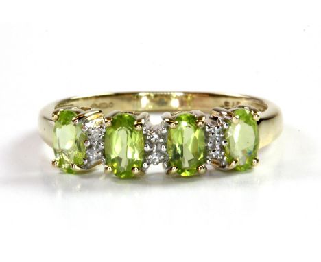 A 9ct yellow gold peridot and diamond set ring, (M.5).