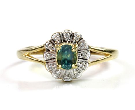 A 9ct yellow gold alexandrite and diamond set cluster ring, (M.5).