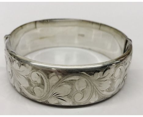 A hinged hallmarked silver bangle.