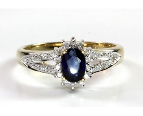 A 9ct yellow gold sapphire and diamond set cluster ring, (L.5).