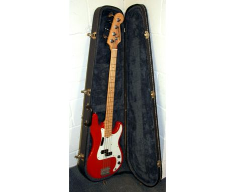 A cased Hohner base guitar.