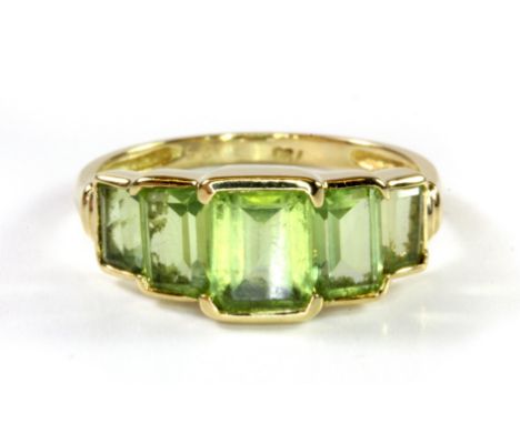 An 18ct yellow gold peridot set ring, (L.5).