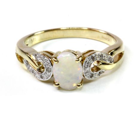 A 9ct yellow gold opal set ring with diamond set shoulders, (N).