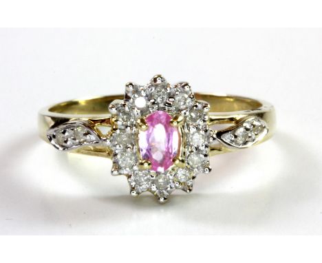 A 9ct yellow gold pink sapphire and diamond cluster ring, (P.5).