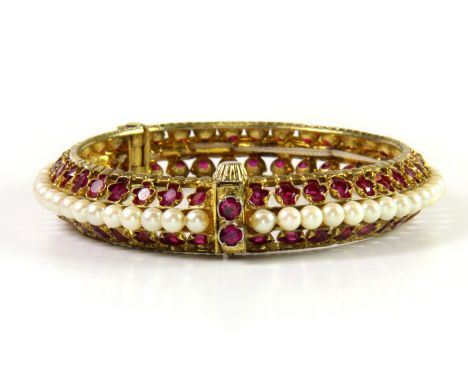 A gilt stone set bangle, internal Dia. 5.4cm.