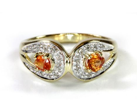 A 9ct yellow gold ring set with orange sapphire and diamonds, (L.5).