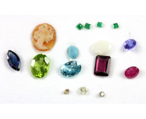 A box of unmounted gemstones, including sapphire, ruby, diamond and opal.