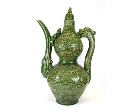 A very large Chinese crackled celadon glazed wine jug and lid, with a dragon handle and elephant trunk spout, H. 61cm.