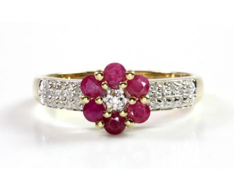 A 9ct yellow gold ruby and diamond set flower shaped cluster ring, (O.5).